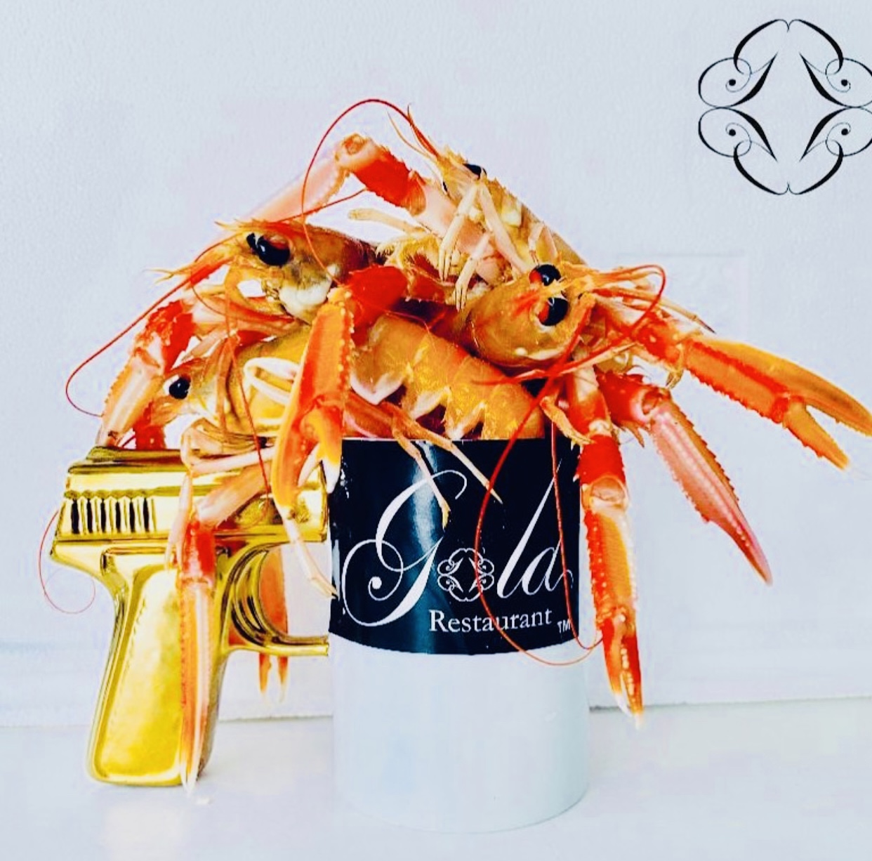 Langoustines presented in a Gola cup with a sculptural golden handle